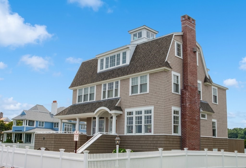 Classic New England coastal beach house with white picket fence built by Chilton Development
